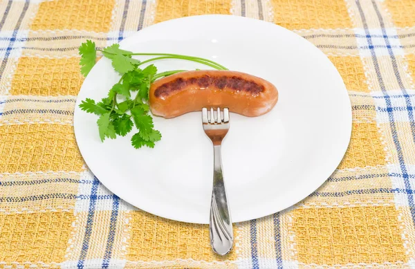 Grilled sausage on a fork and branch of coriander — Stok fotoğraf