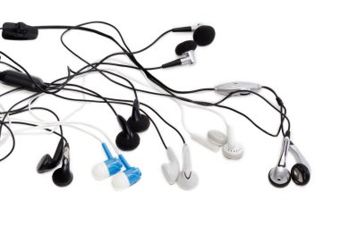 Several various earbuds on a light background