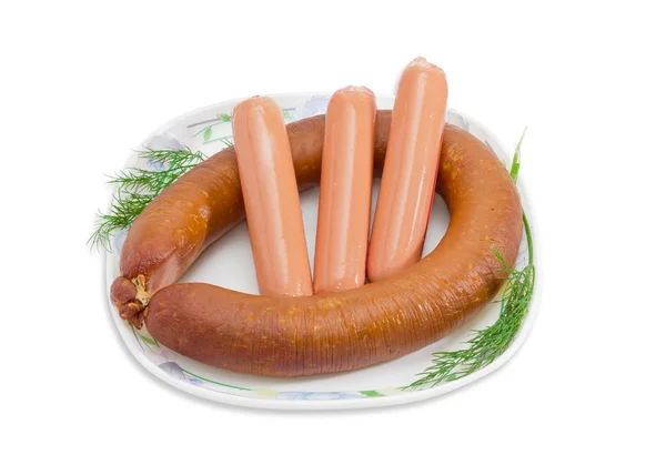 Sausages with branches of dill on a white dish — Stockfoto