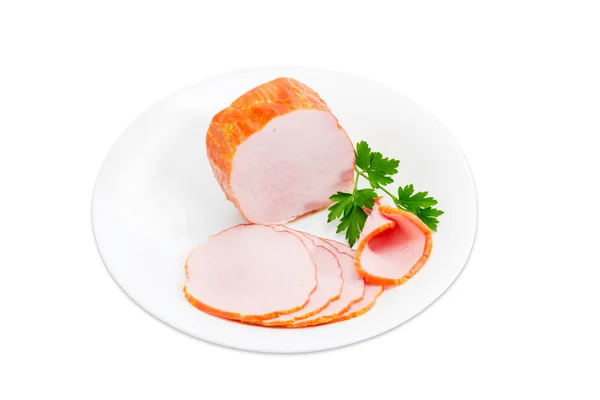 Οσφυϊκή χώρα χοιρινού κρέατος και κλαδάκι μαϊντανό σε ένα άσπρο πιάτο — Φωτογραφία Αρχείου