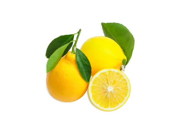 Two whole lemons with leaves and one cut lemon — Stok fotoğraf