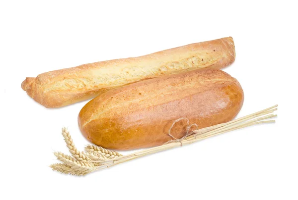 Baguette, wheat bread and bundle of wheat ears — 图库照片