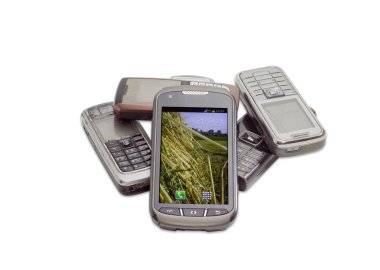 Modern smartphone on the background of old mobile phones clipart