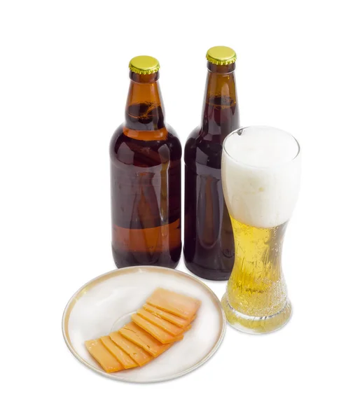 Glass and two bottles of beer, cheese on light background — Stock Photo, Image