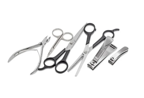 Several different nail clippers, nail scissors and two hairdress — Stock Photo, Image