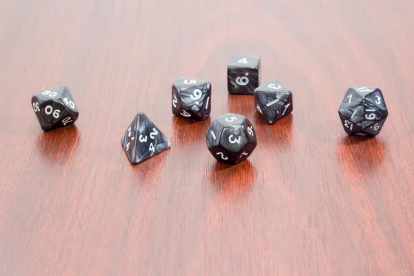 Specialized polyhedral dice for role-playing games on wooden sur — Stock Photo, Image