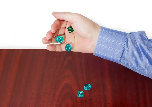 Specialized polyhedral dice thrown from male hand on wooden surf — Stock Photo, Image