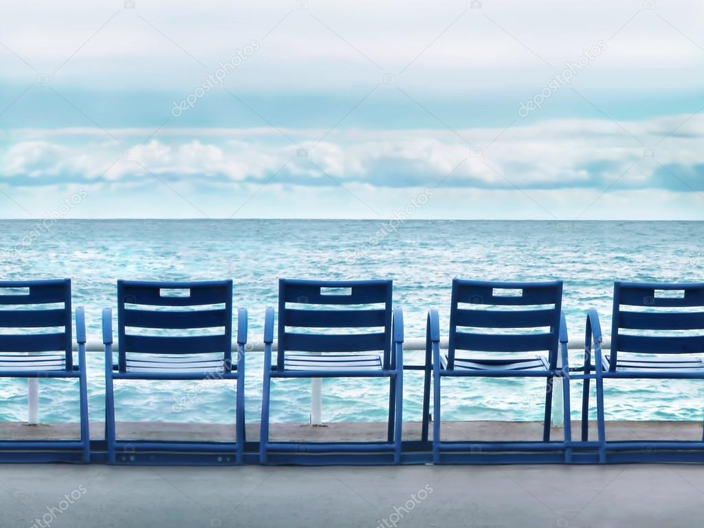 Row of blue chairs on the Cote d'Azur in Nice
