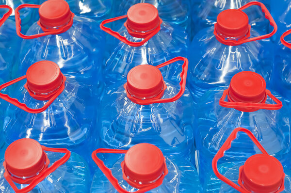 Several large blue plastic aqua bottles