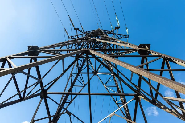 A rusty power line is on the blue sky background