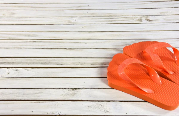 Orange flip-flops on wood deck — Stock Photo, Image
