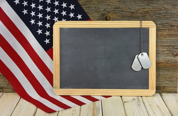 Military dog tags on black chalkboard — Stock Photo, Image