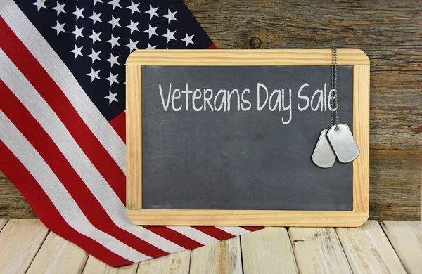 Veterans Day Sale on black chalkboard with dog tags — Stock Photo, Image