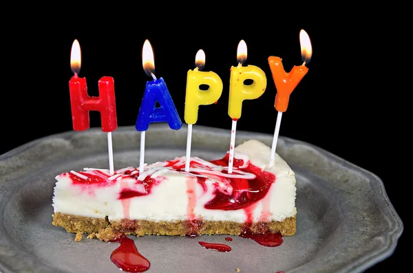 Birthday candles in cheesecake — Stock Photo, Image