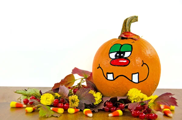 Funny fall pumpkin in leaves — Stock Photo, Image