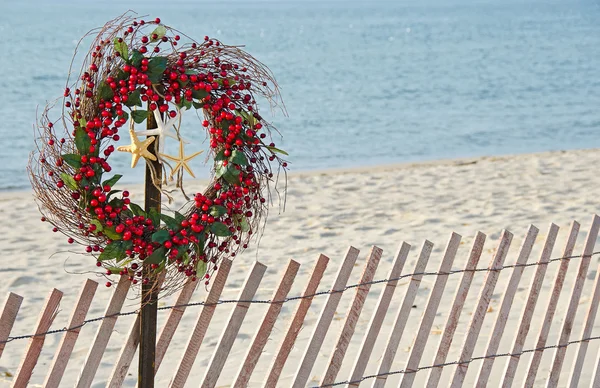 Christmas wreath on beach fence — Stock Photo, Image