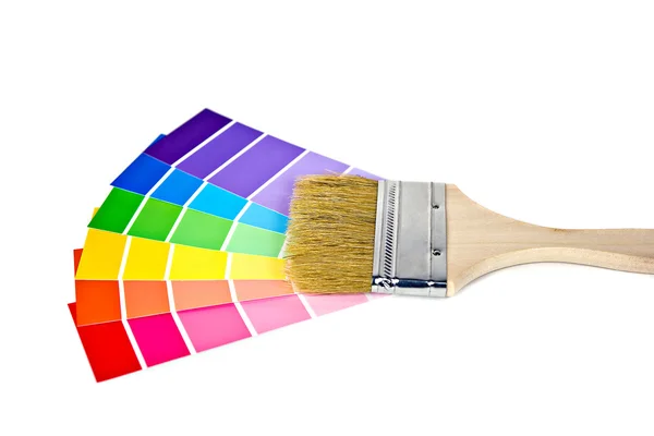 Paint brush on a paint chips — Stock Photo, Image