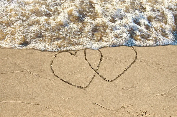 Par i hjärter i sand — Stockfoto