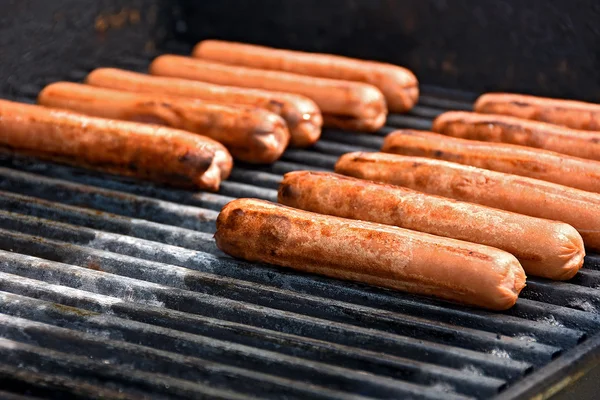 Hot dogs on barbecue grill — Stock Photo, Image