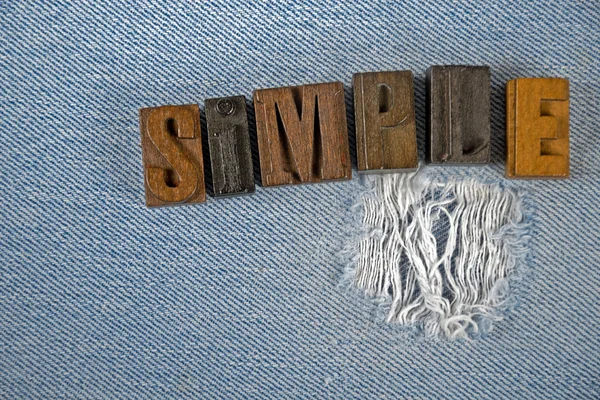 Typ jednoduché knihtisk slovo na podkladové látce roztřepený modrá jean — Stock fotografie