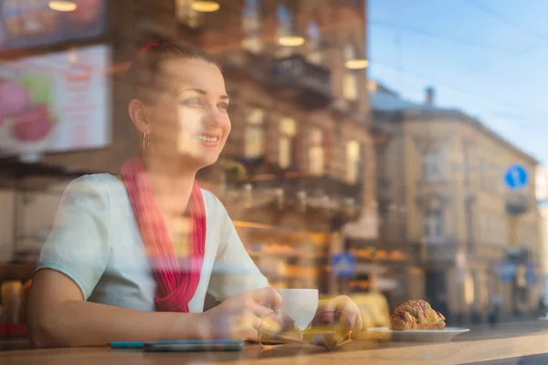 stock image young woman through glass