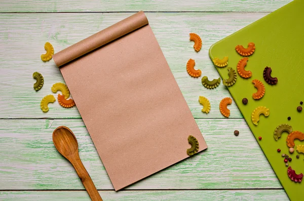 Notebook with noodles on wooden — Stock Photo, Image