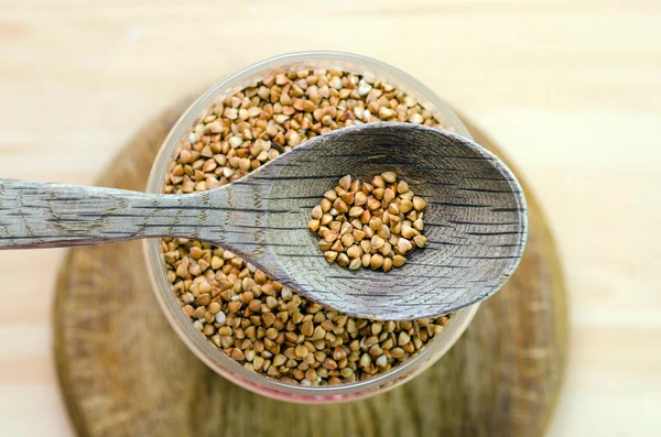 Wooden spoon with a buckwheat — Stock Photo, Image