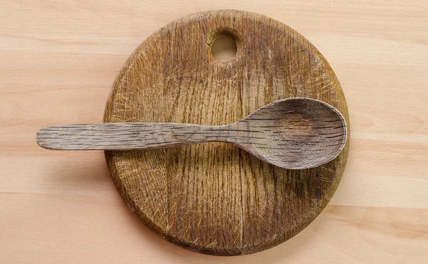 Wooden spoon on a board — Stock Photo, Image