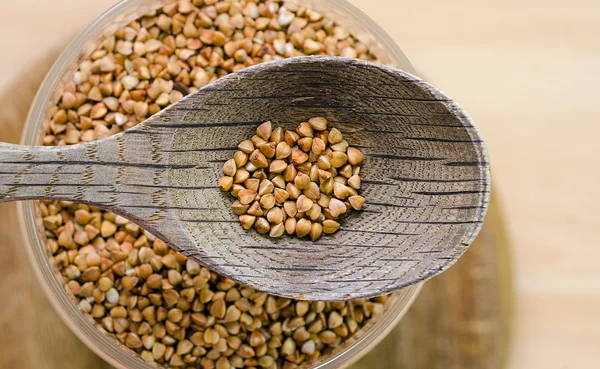 Wooden spoon with a buckwheat — Stock Photo, Image