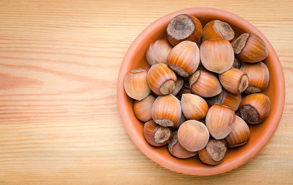 Hazelnut in clay plate — Stock Photo, Image