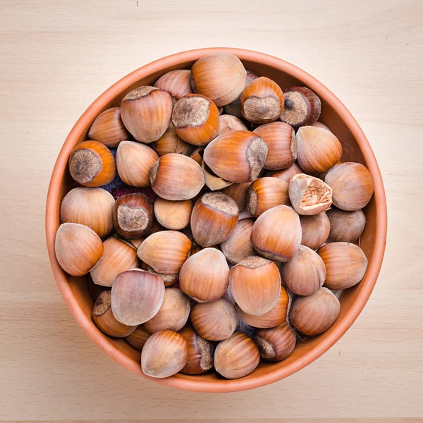 Hazelnut on the brown wood — Stock Photo, Image