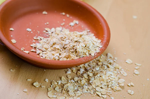 Raw oatmeal in a bowl — Stock Photo, Image