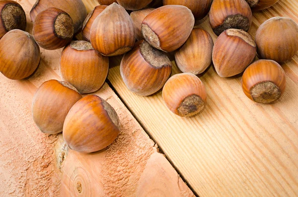 Heap of hazelnuts on wood — Stock Photo, Image