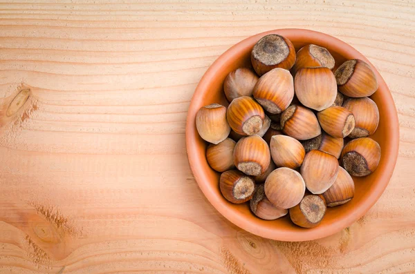 Heap of hazelnuts in bowl — Stock Photo, Image