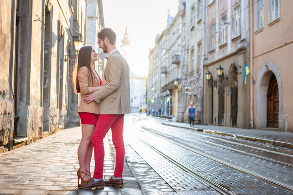 couple posing on streets of Europe