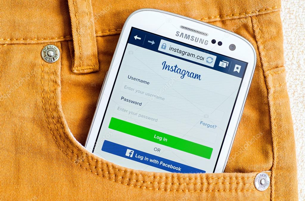 LVIV, UKRAINE - May 19, 2015: White Samsung Galaxy Smart Phone with Instagram social network Log In Screen in orange jeans pocket
