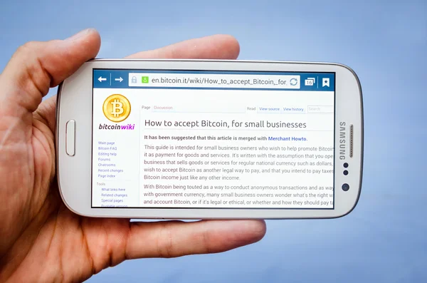 Business, technologie en internetconcept - zakenman en zakenvrouw met bitcoin ondertekenen op smartphone schermen — Stockfoto