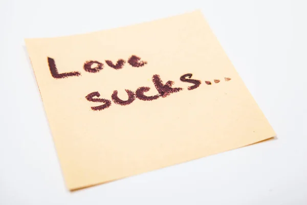 Close Love Sucks Note Handwritten Yellow Sticky Paper — Stock Photo, Image