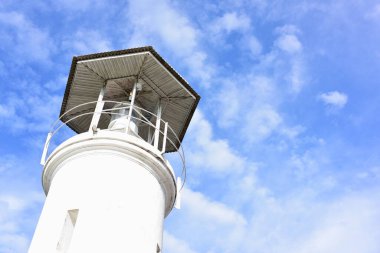 lighthouse on the sky background with clouds 