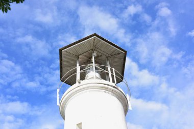 lighthouse on the sky background with clouds 