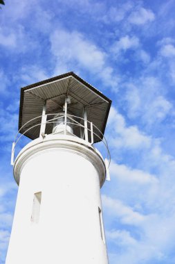lighthouse on the sky background with clouds 