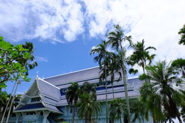 Traditional thai building and palm trees