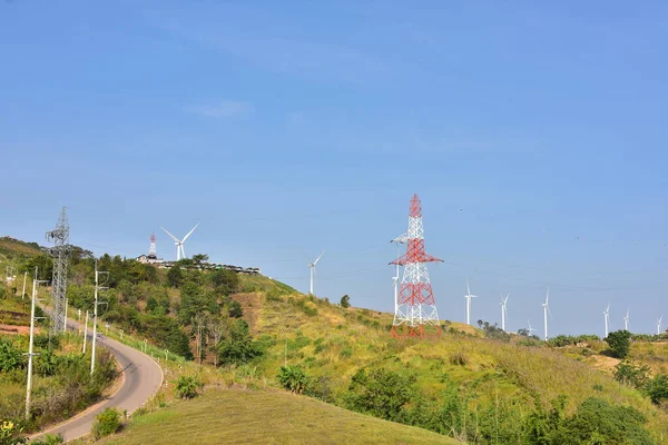 Wind turbines and high voltage towers in mountains