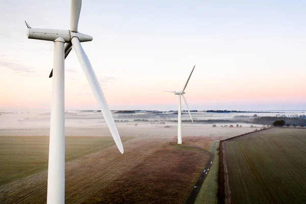 Aerial View Two Wind Turbines Close Sunrise Fog English Countryside —  Fotos de Stock