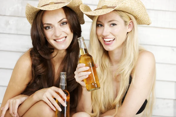 Two friends in beachwear and hats — Stock Photo, Image