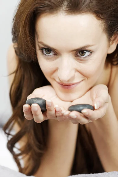 Woman with spa hot rocks — Stock Photo, Image