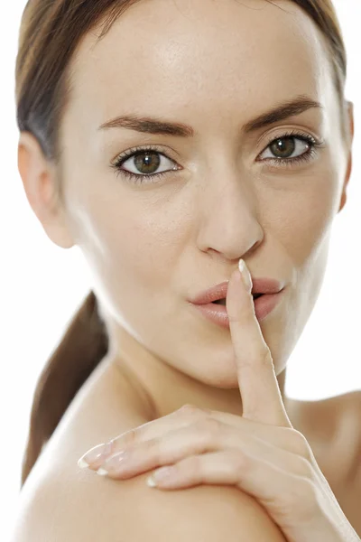 Mujer sosteniendo su dedo sobre sus labios — Foto de Stock