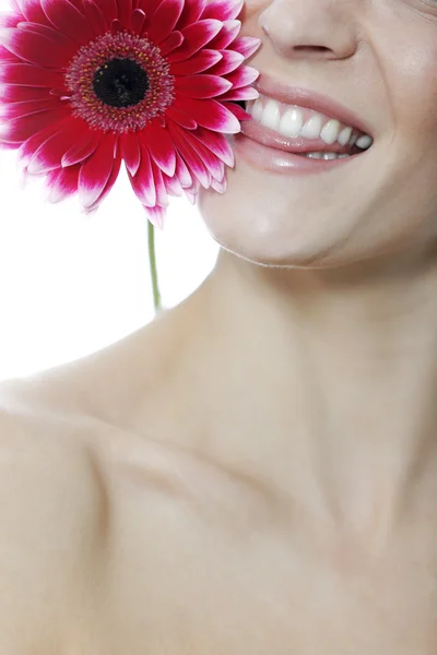 Woman biting at red flower — Stock Photo, Image