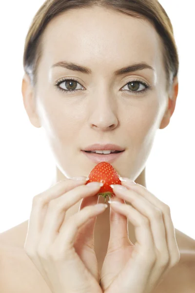 Woman enjoying a fresh strawberry — Stock Photo, Image