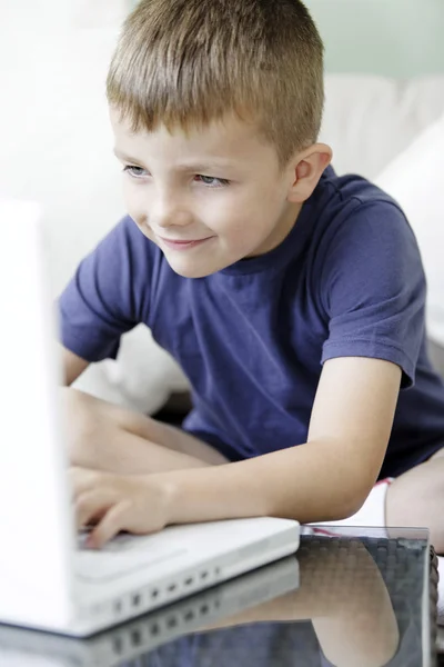 Young boy on a laptop Royalty Free Stock Photos